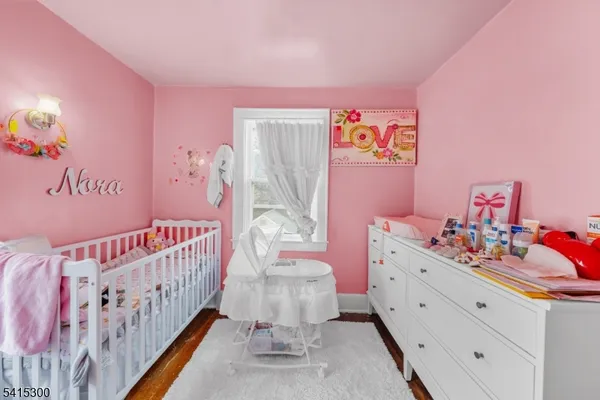 a bedroom with furniture and a baby crib