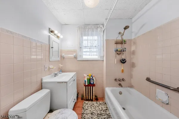 a bathroom with a sink toilet tub and shower