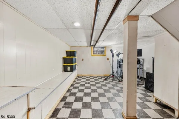 a bathroom with a black and white checkered floor