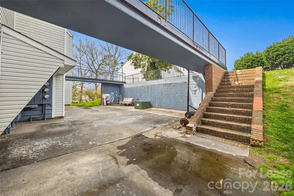 a view of a house with backyard space and wooden deck