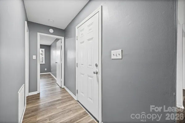 a view of a hallway with wooden floor