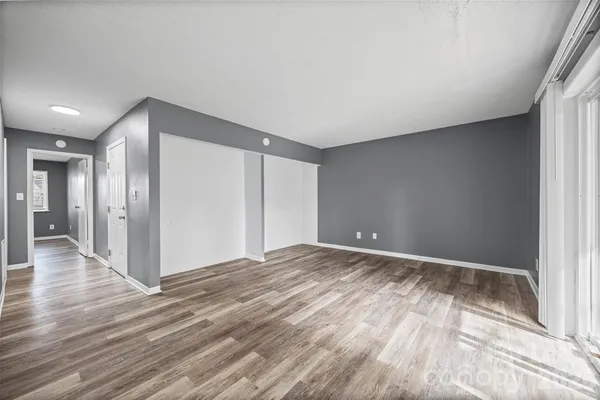 a view of an empty room and wooden floor