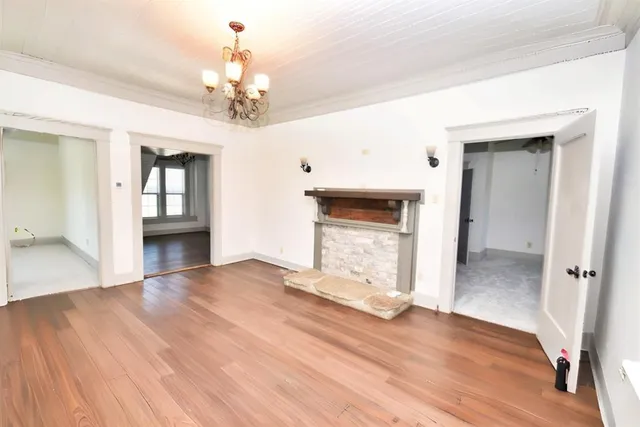 a view of entryway and hall with wooden floor