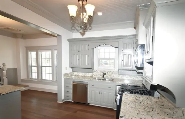 an empty room with closet and windows