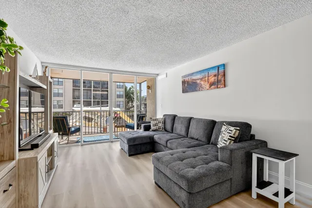 a kitchen with a refrigerator and white cabinets