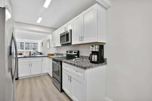 a view of a lake with houses in the back