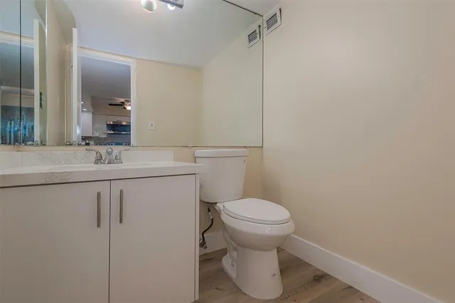 a view of a room with wooden floor