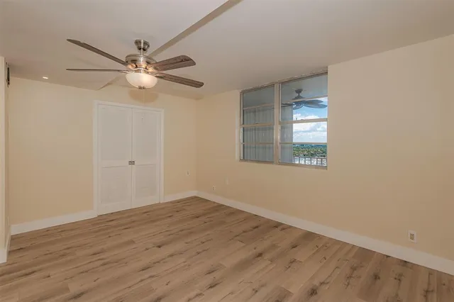 a view of an empty room with wooden floor