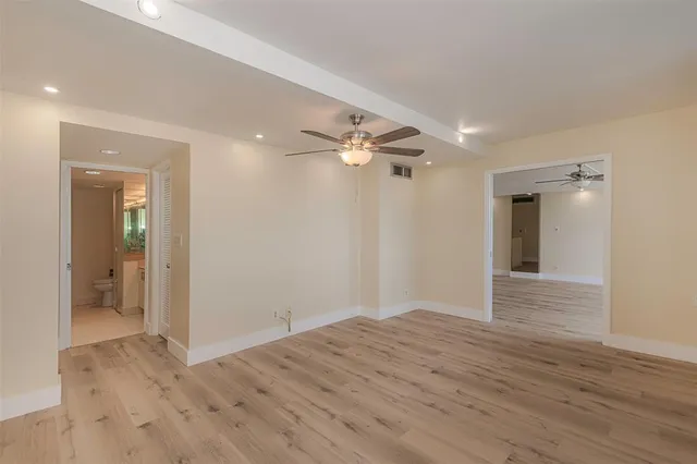 a bathroom with a granite countertop sink mirror and toilet