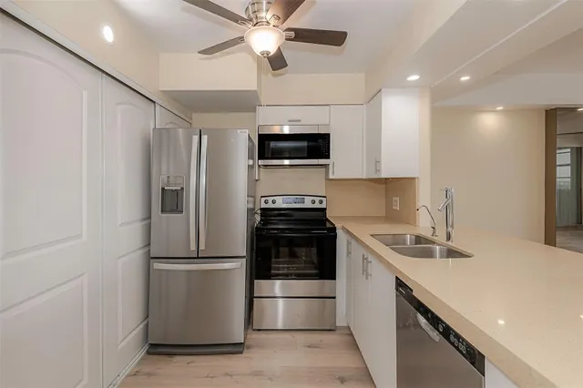 a kitchen with a sink and a stove top oven