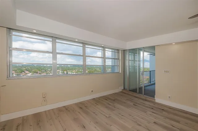 wooden floor in an empty room with a window