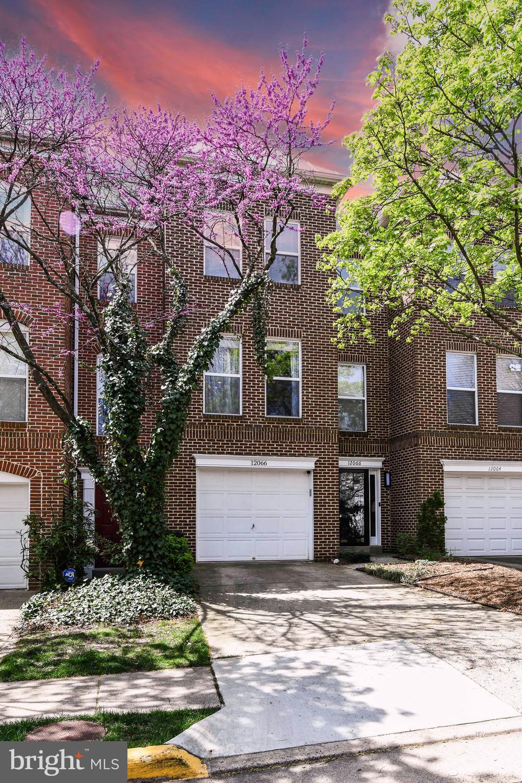 12066 Edgemere Circle Reston, VA 20190 - Photo 1 of 28 a front view of a house with a yard and garage