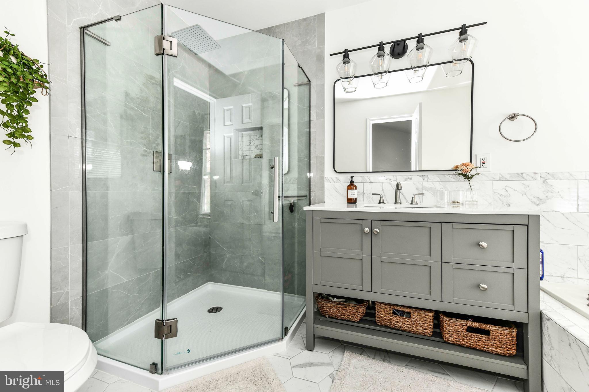 12066 Edgemere Circle Reston, VA 20190 - Photo 23 of 28 a bathroom with a tub sink and mirror