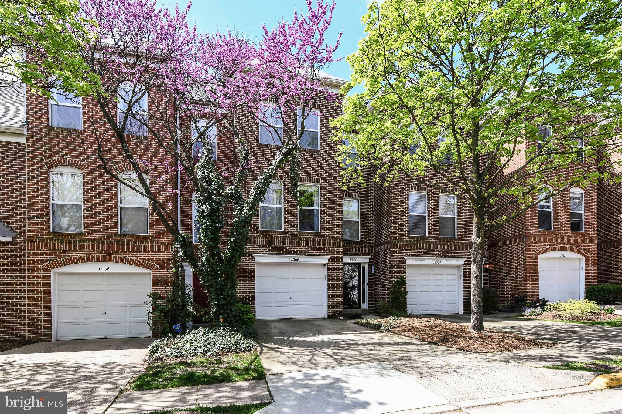 12066 Edgemere Circle Reston, VA 20190 - Photo 28 of 28 a front view of a house with a yard and garage