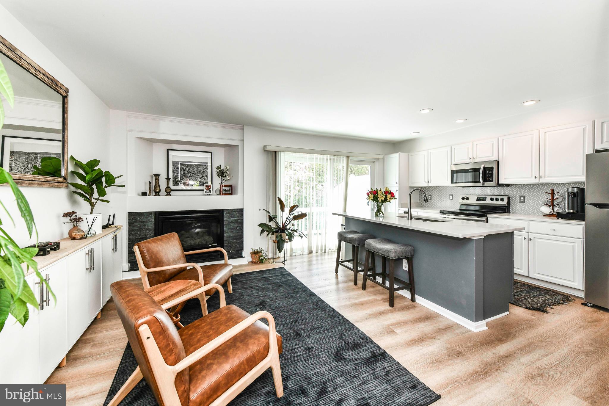 12066 Edgemere Circle Reston, VA 20190 - Photo 6 of 28 a kitchen with a table chairs refrigerator and microwave