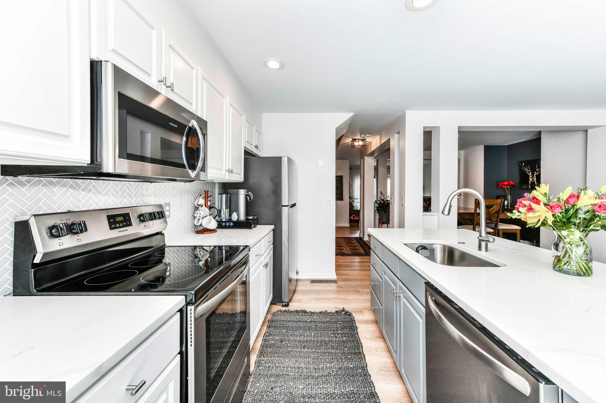 12066 Edgemere Circle Reston, VA 20190 - Photo 8 of 28 a kitchen with a sink stove and microwave