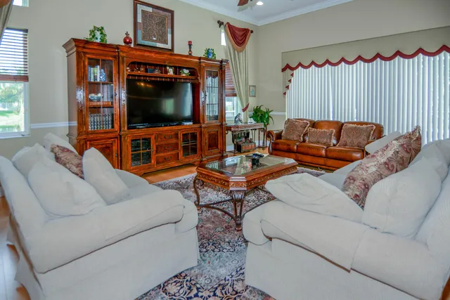a bedroom with a bed dresser and a flat tv screen