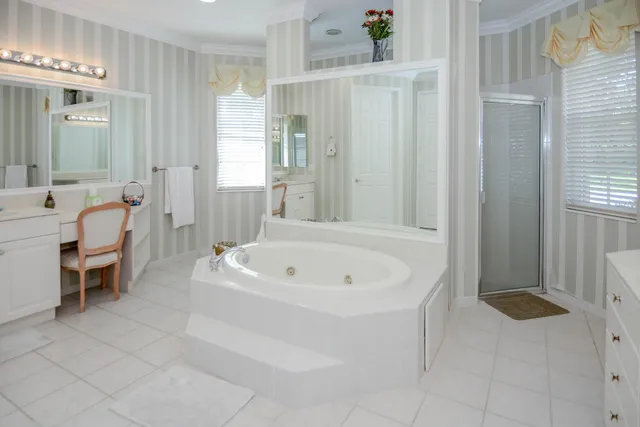 a spacious bathroom with a double vanity sink a mirror and a shower