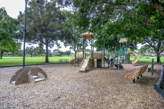 a view of pathway in front of house with palm trees