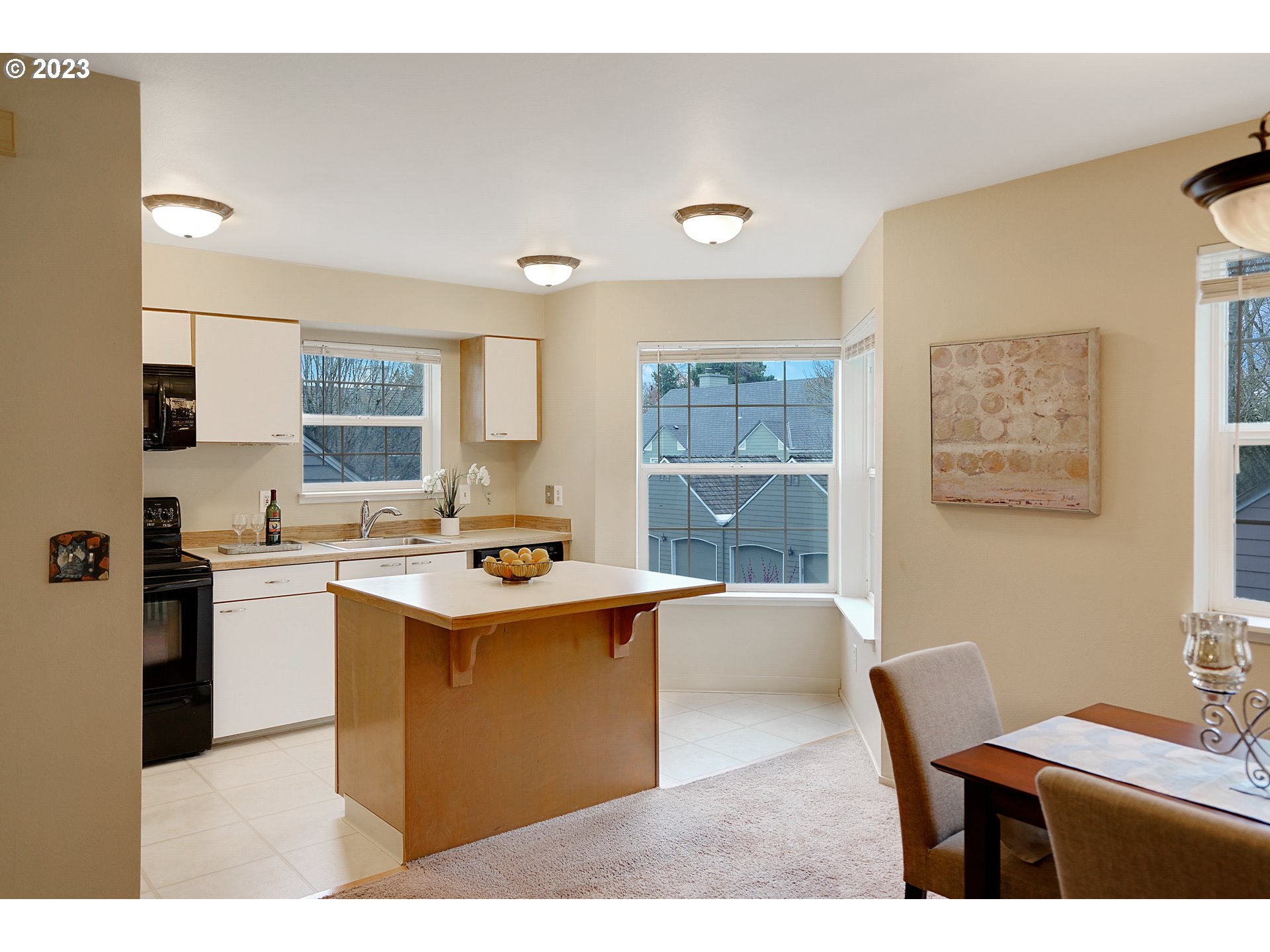8415 Southwest Curry Drive, Unit A Wilsonville, OR 97070 - Photo 12 of 36 a kitchen with kitchen island a sink stove and refrigerator