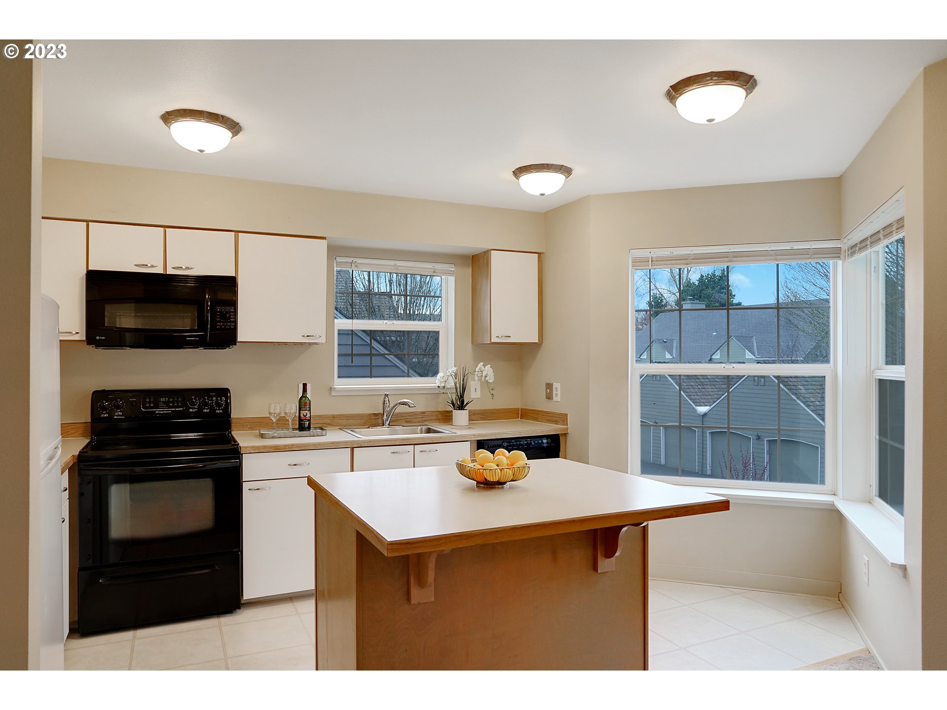 8415 Southwest Curry Drive, Unit A Wilsonville, OR 97070 - Photo 13 of 36 a kitchen with a sink a stove and cabinets