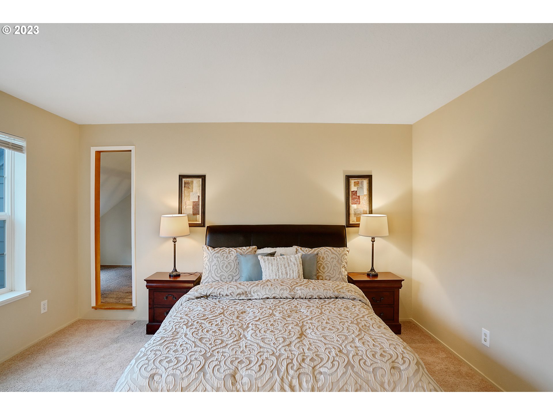 8415 Southwest Curry Drive, Unit A Wilsonville, OR 97070 - Photo 21 of 36 a bedroom with a bed and a night stand