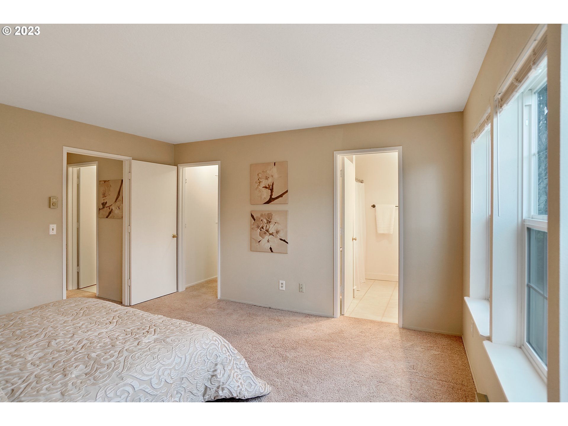8415 Southwest Curry Drive, Unit A Wilsonville, OR 97070 - Photo 23 of 36 a bedroom with a bed and a painting on the wall
