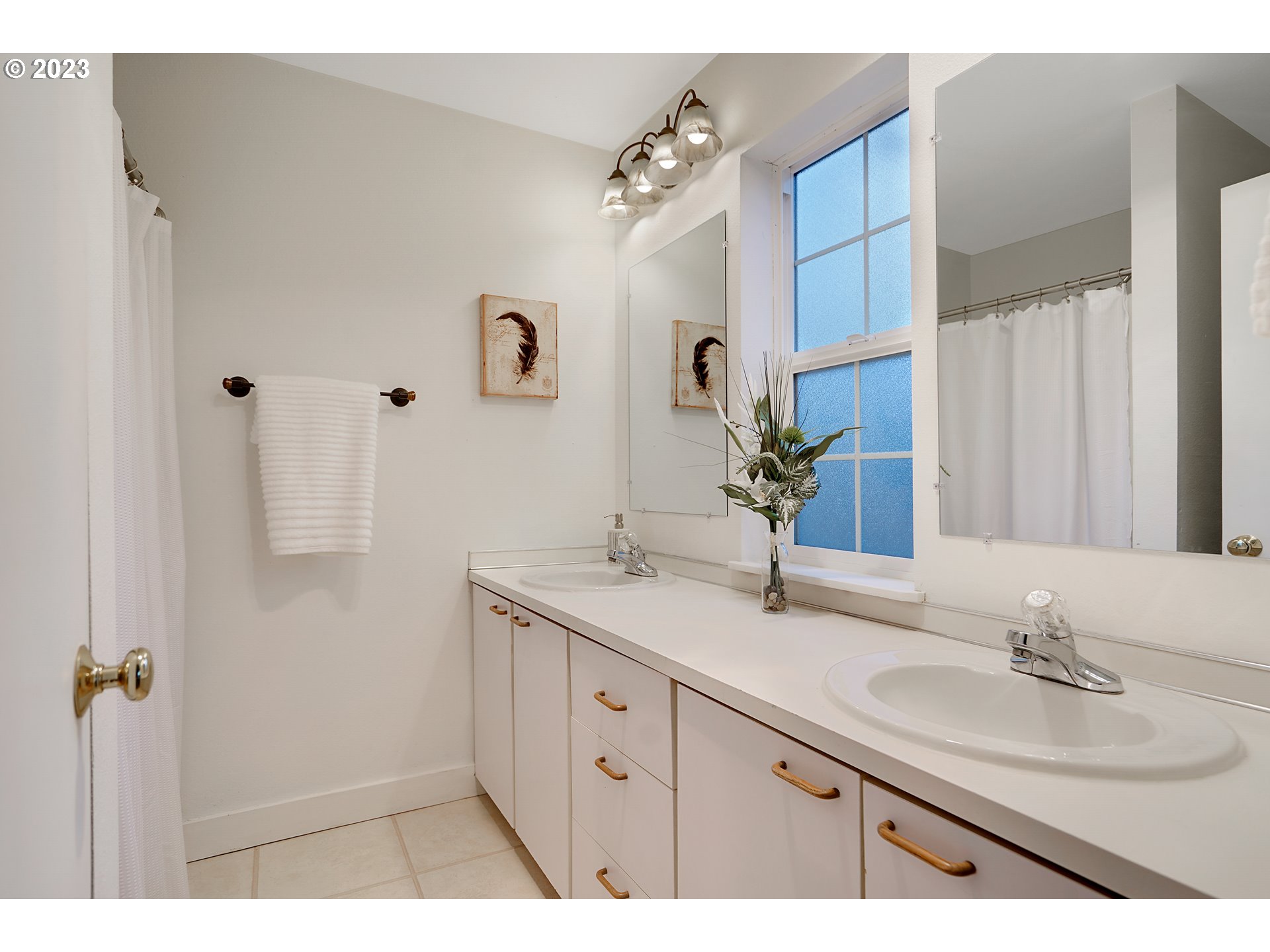 8415 Southwest Curry Drive, Unit A Wilsonville, OR 97070 - Photo 26 of 36 a bathroom with a double vanity sink mirror and shower