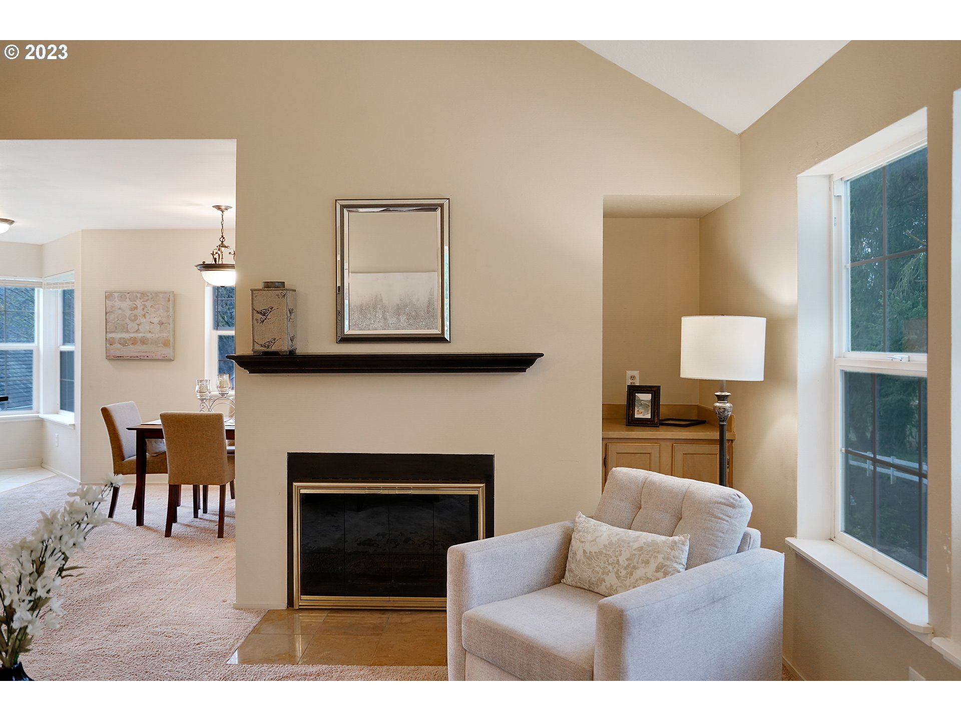8415 Southwest Curry Drive, Unit A Wilsonville, OR 97070 - Photo 6 of 36 a living room with furniture a fireplace and a flat screen tv