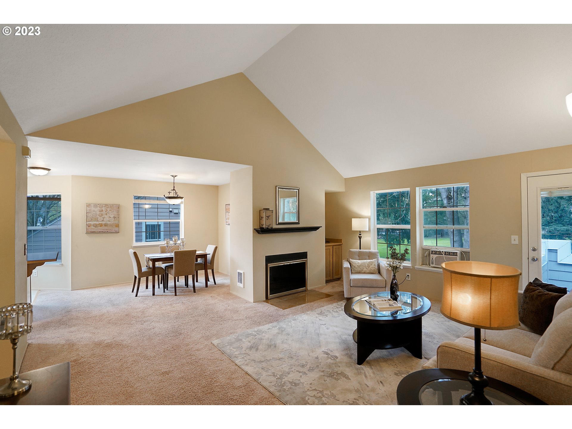 8415 Southwest Curry Drive, Unit A Wilsonville, OR 97070 - Photo 7 of 36 a living room with furniture a fireplace and a flat screen tv
