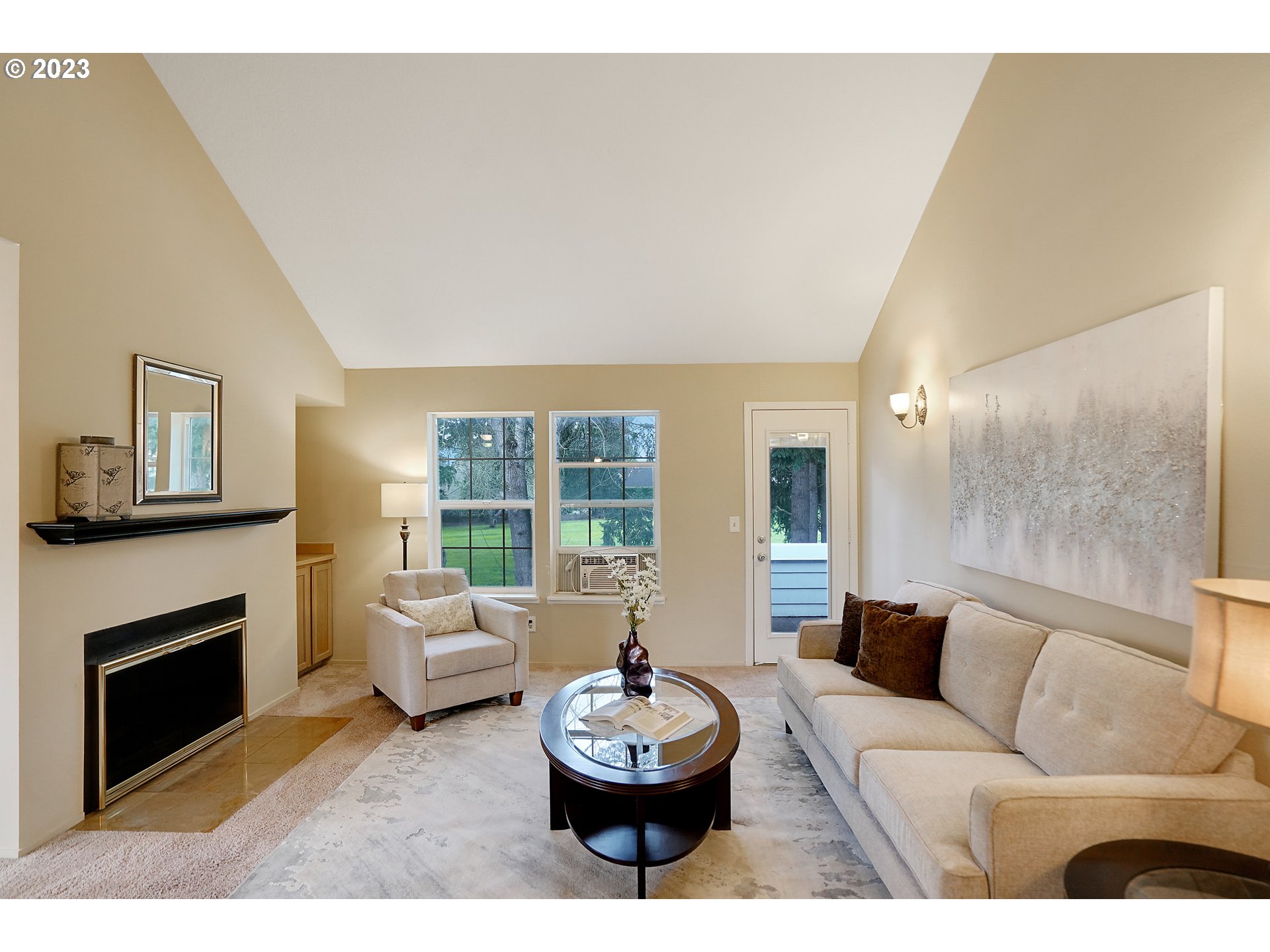 8415 Southwest Curry Drive, Unit A Wilsonville, OR 97070 - Photo 8 of 36 a living room with furniture a window and a fireplace