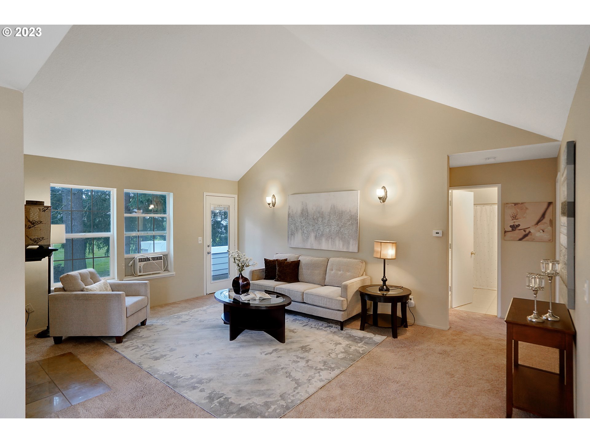 8415 Southwest Curry Drive, Unit A Wilsonville, OR 97070 - Photo 10 of 36 a living room with furniture and a large window