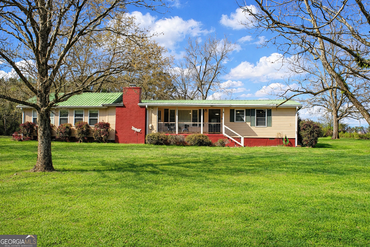 a front view of a house with a yard table and chairs