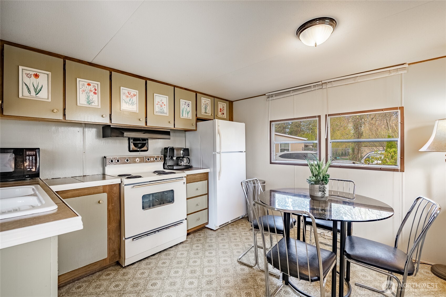 5178 Anderson Road Blaine, WA 98230 - Photo 10 of 37 a kitchen with a stove a refrigerator and a dining table