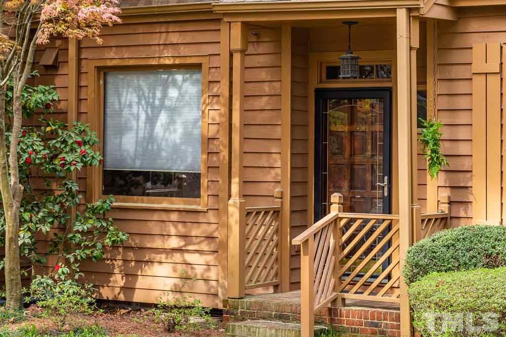 7643 Trowbridge Court Raleigh, NC 27613 - Photo 2 of 26 a front view of a house with a iron gate