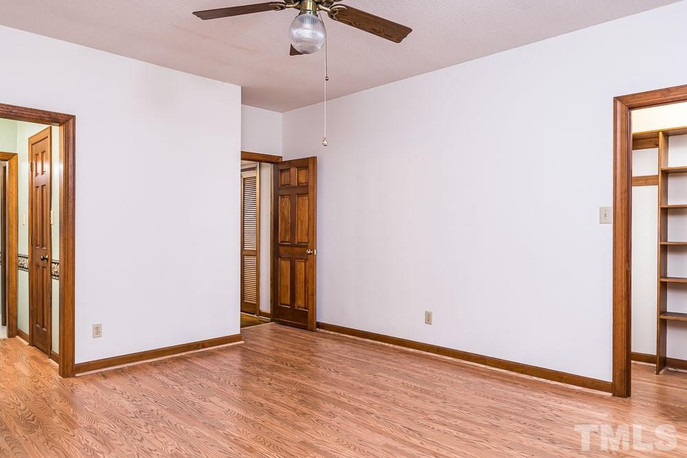 7643 Trowbridge Court Raleigh, NC 27613 - Photo 14 of 26 an empty room with wooden floor closet and windows