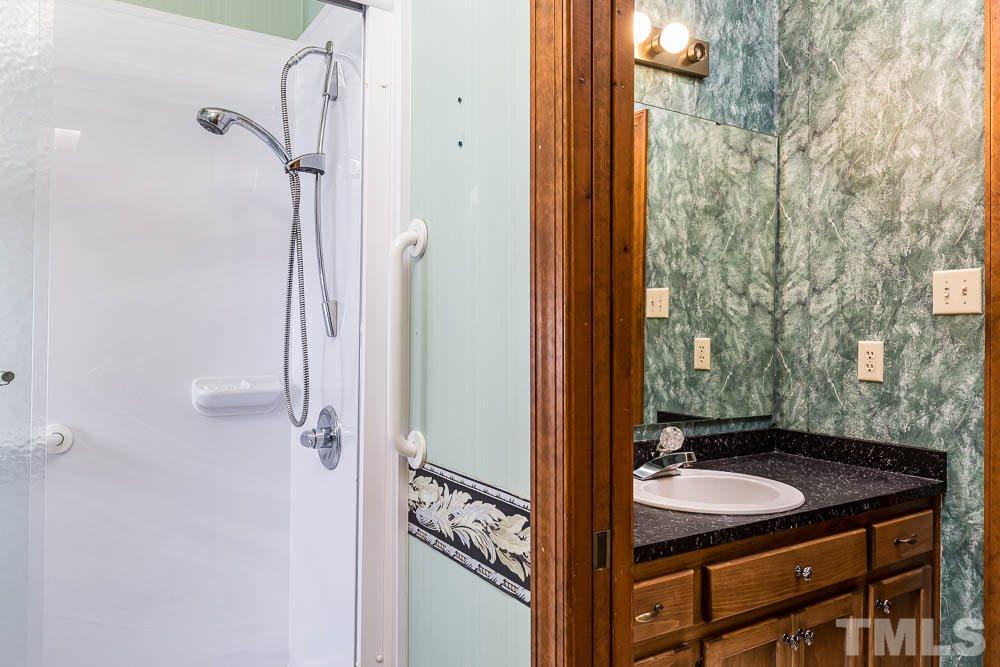 7643 Trowbridge Court Raleigh, NC 27613 - Photo 16 of 26 a bathroom with a sink and a mirror