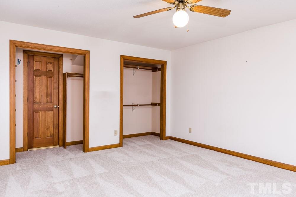 7643 Trowbridge Court Raleigh, NC 27613 - Photo 17 of 26 an empty room with chandelier fan
