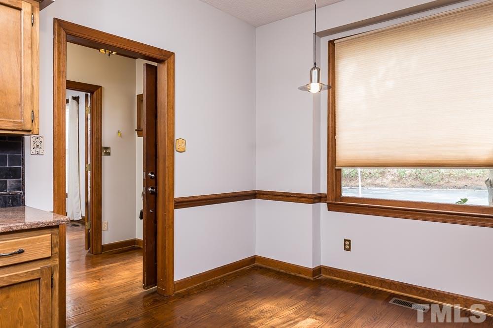 7643 Trowbridge Court Raleigh, NC 27613 - Photo 5 of 26 a view of a room with wooden floor and a window