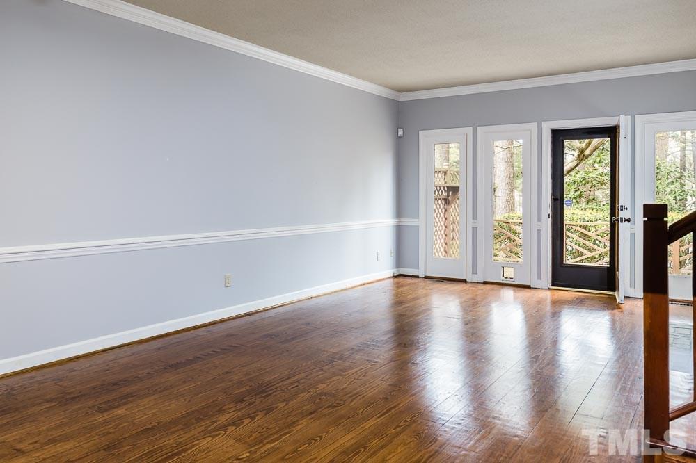 7643 Trowbridge Court Raleigh, NC 27613 - Photo 10 of 26 a view of an empty room with wooden floor and a window