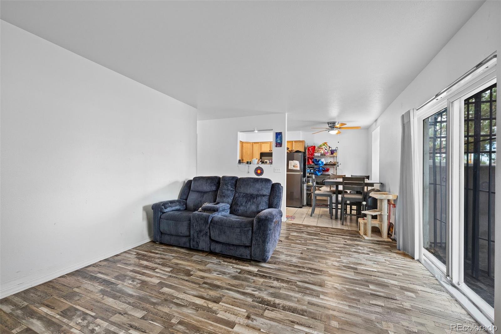 9240 West 49th Avenue, Unit 306 Wheat Ridge, CO 80033 - Photo 1 of 14 a living room with furniture and a wooden floor