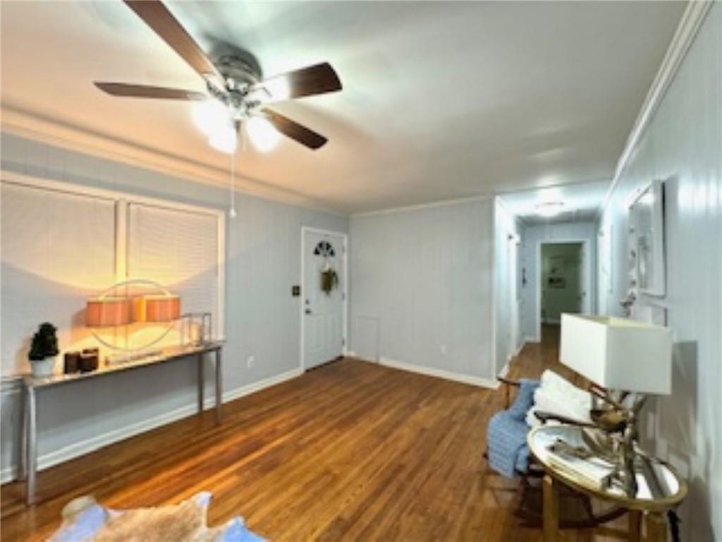 209 Moultrie Lane Southwest Rome, GA 30161 - Photo 17 of 46 a view of a room with wooden floor a ceiling fan and windows