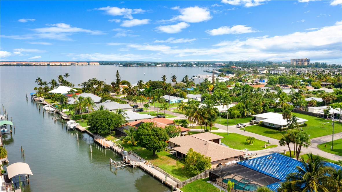 an aerial view of a house with a swimming pool outdoor seating and yard