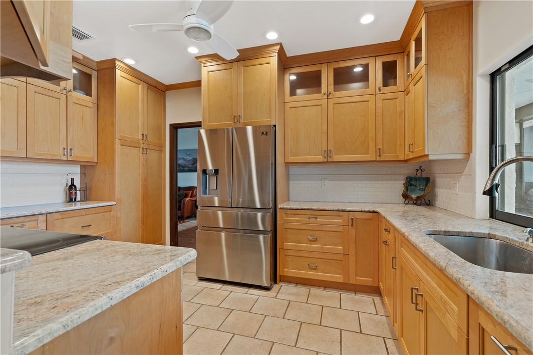 1713 Sunset Isles Road Fort Pierce, FL 34949 - Photo 13 of 36 a kitchen with granite countertop a refrigerator and a sink