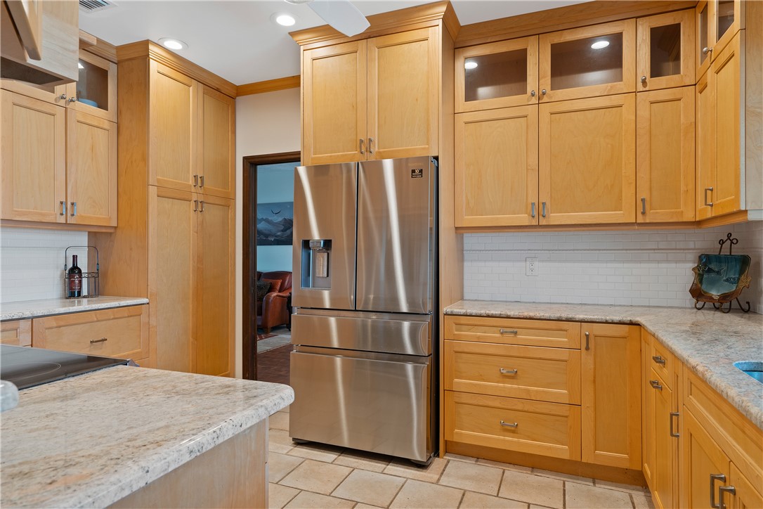 1713 Sunset Isles Road Fort Pierce, FL 34949 - Photo 17 of 36 a kitchen with stainless steel appliances granite countertop a refrigerator and a sink