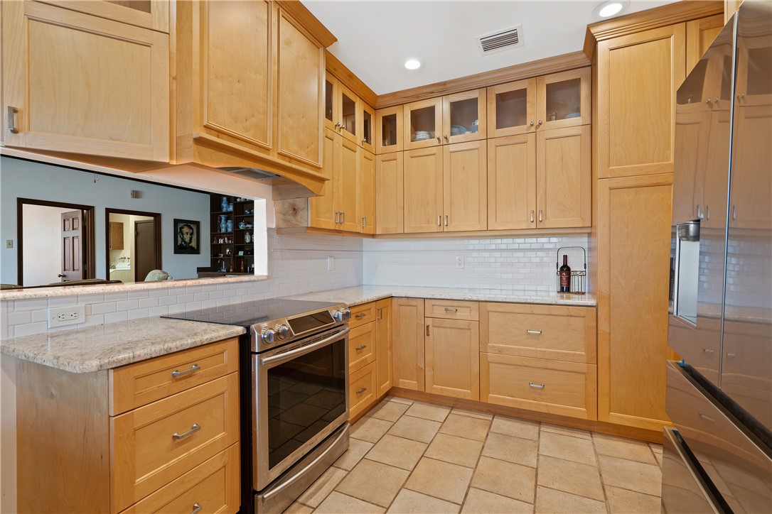 1713 Sunset Isles Road Fort Pierce, FL 34949 - Photo 18 of 36 a kitchen with stainless steel appliances granite countertop a stove and a sink