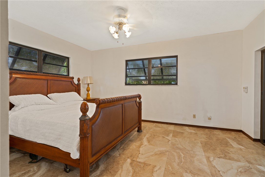 1713 Sunset Isles Road Fort Pierce, FL 34949 - Photo 21 of 36 a bed room with a bed