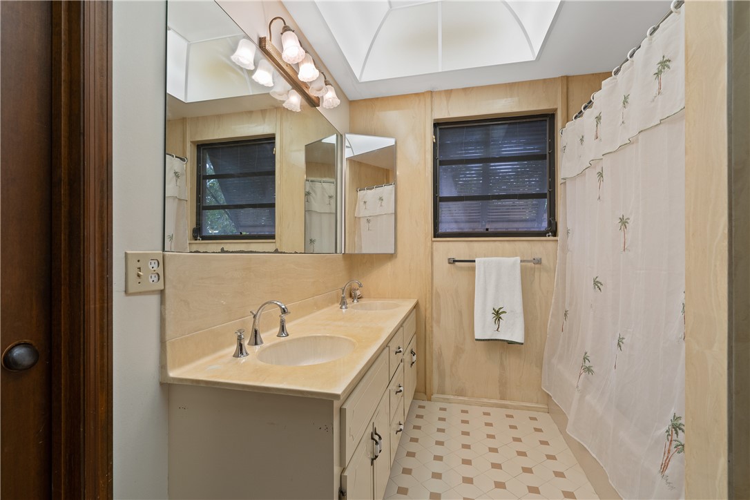 1713 Sunset Isles Road Fort Pierce, FL 34949 - Photo 22 of 36 a bathroom with a sink and a mirror