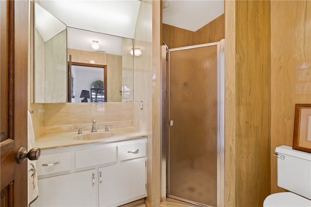 1713 Sunset Isles Road Fort Pierce, FL 34949 - Photo 25 of 36 a bathroom with a sink and mirror with toilet