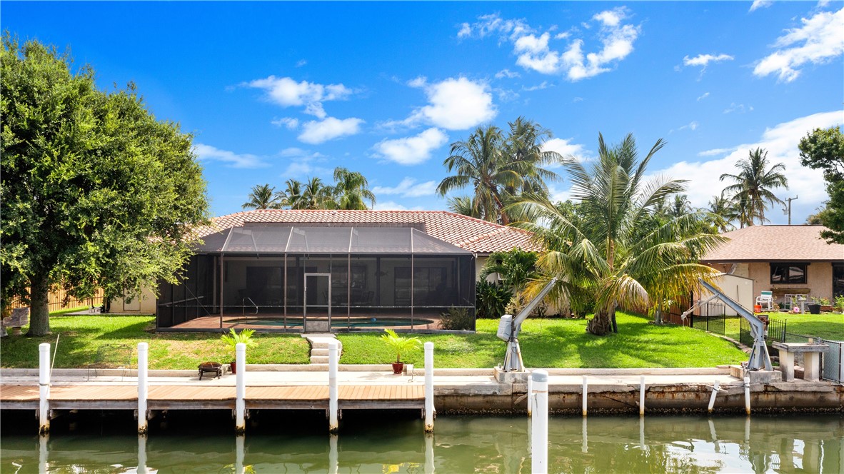 1713 Sunset Isles Road Fort Pierce, FL 34949 - Photo 28 of 36 a view of an house with swimming pool and porch